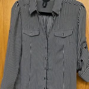 Black and white striped blouse with adjustable sleeves.